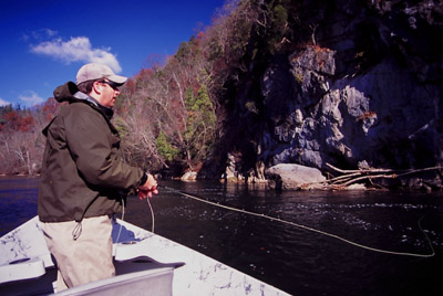 Fly fishing with a streamer from a drift boat.
